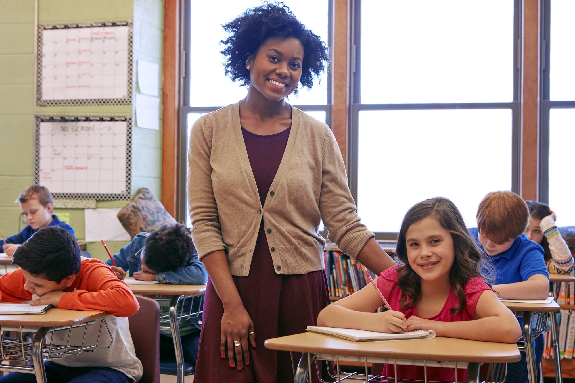 Shot of a teacher in a classroom with her students.